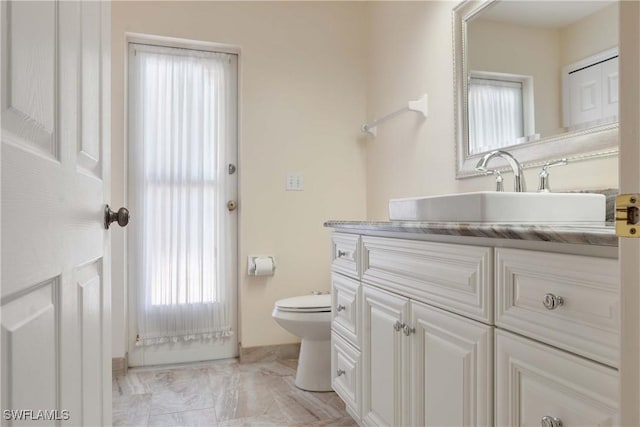 212 SE 30th Ter, Cape Coral, FL 33904 - bathroom featuring toilet, healthy amount of natural light, and vanity