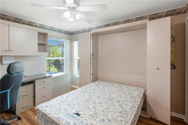 212 SE 30th Ter, Cape Coral, FL 33904 - bedroom featuring wood finished floors, a desk, baseboards, and ceiling fan