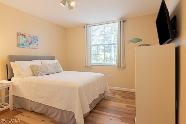 8617 River Homes Ln Unit 3108, Bonita Springs, FL 34135 - bedroom with light wood-style floors and baseboards