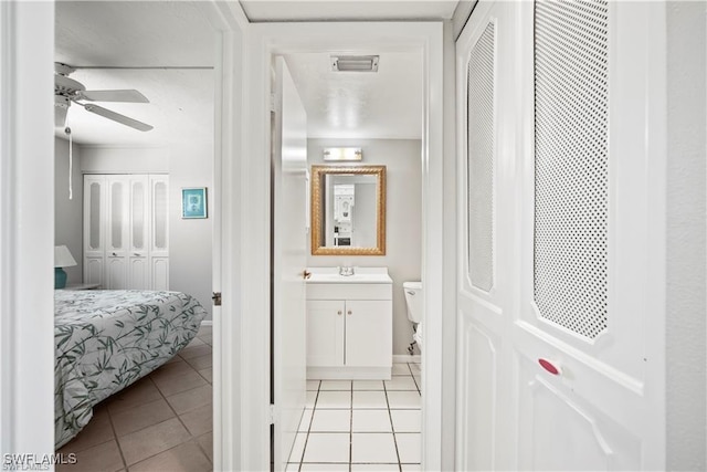 1624 Pine Valley Dr Unit 115, Fort Myers, FL 33907 - ensuite bathroom featuring tile patterned floors, toilet, visible vents, ceiling fan, and vanity