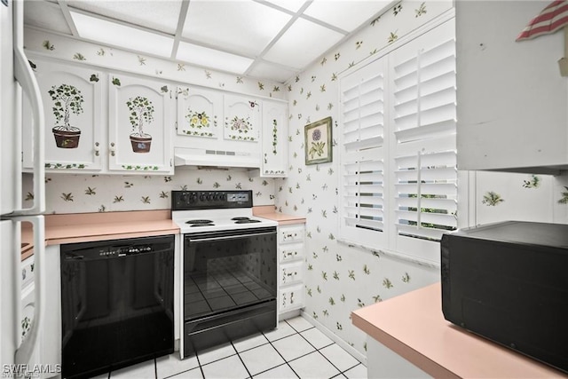 1624 Pine Valley Dr Unit 115, Fort Myers, FL 33907 - kitchen with wallpapered walls, black appliances, light countertops, white cabinets, and under cabinet range hood