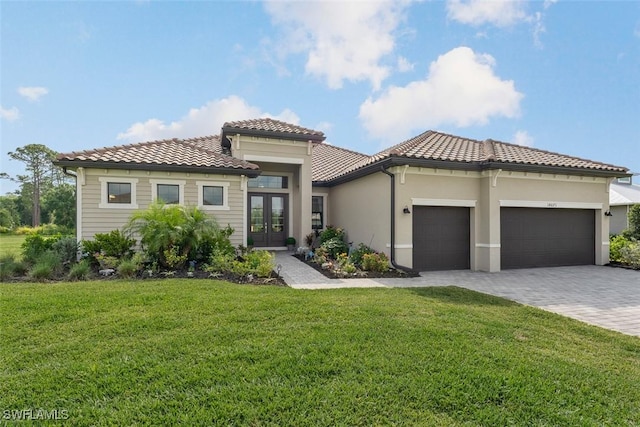 14071 Binghampton Dr, Fort Myers, FL 33905 - view of front of property with french doors, a garage, a front yard, a tile roof, and decorative driveway