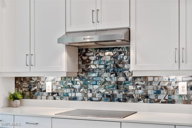 14071 Binghampton Dr, Fort Myers, FL 33905 - kitchen featuring exhaust hood, black electric stovetop, and white cabinetry