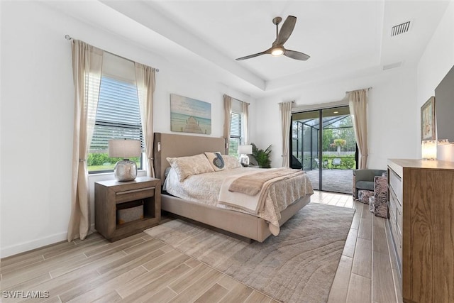 14071 Binghampton Dr, Fort Myers, FL 33905 - bedroom with a tray ceiling, access to exterior, light wood-style floors, and ceiling fan