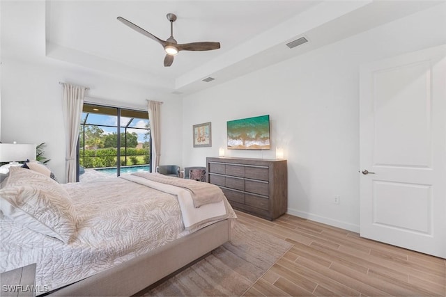 14071 Binghampton Dr, Fort Myers, FL 33905 - bedroom with a raised ceiling, access to exterior, light wood-style flooring, and a ceiling fan