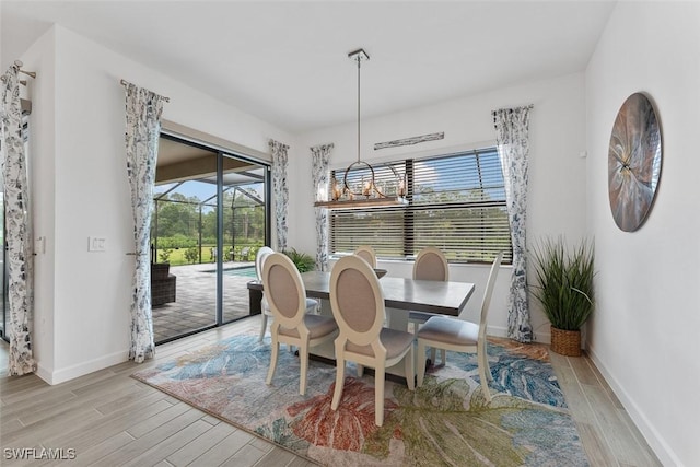 14071 Binghampton Dr, Fort Myers, FL 33905 - dining room with light wood finished floors and a chandelier