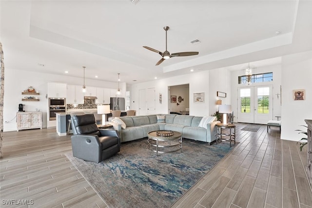 14071 Binghampton Dr, Fort Myers, FL 33905 - living room featuring a raised ceiling, recessed lighting, light wood-type flooring, and ceiling fan