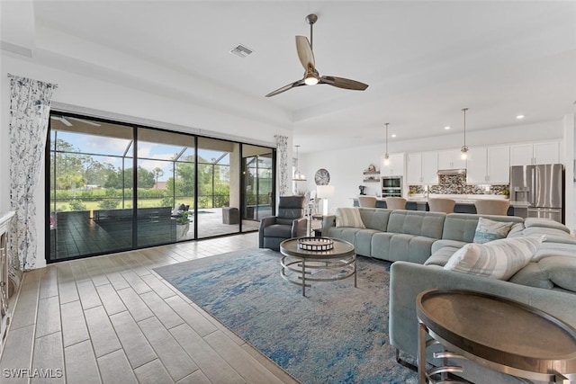 14071 Binghampton Dr, Fort Myers, FL 33905 - living room with ceiling fan, light wood-type flooring, recessed lighting, and a raised ceiling