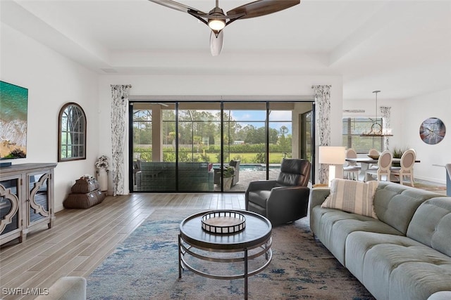 14071 Binghampton Dr, Fort Myers, FL 33905 - living area featuring wood finished floors, plenty of natural light, a chandelier, and a raised ceiling