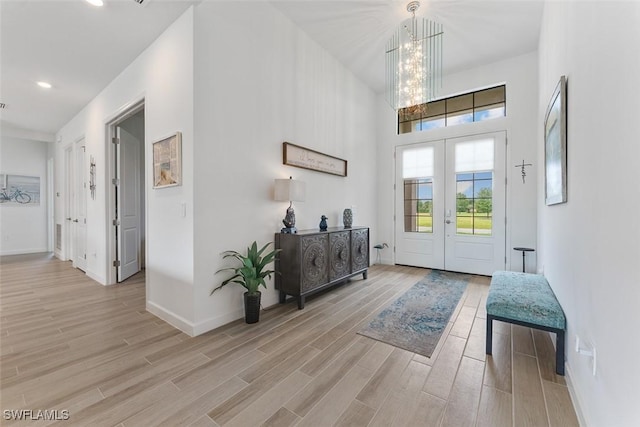 14071 Binghampton Dr, Fort Myers, FL 33905 - entrance foyer with light wood-style floors, a chandelier, french doors, recessed lighting, and a towering ceiling