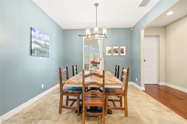 4551 Fort Center Ave, Fort Denaud, FL 33935 - dining room featuring stone tile floors, baseboards, visible vents, and a notable chandelier