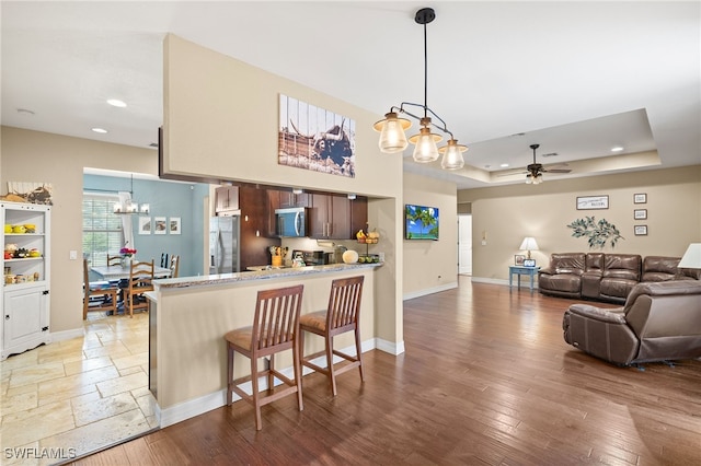 4551 Fort Center Ave, Fort Denaud, FL 33935 - kitchen featuring a kitchen breakfast bar, ceiling fan with notable chandelier, stainless steel appliances, a peninsula, and recessed lighting
