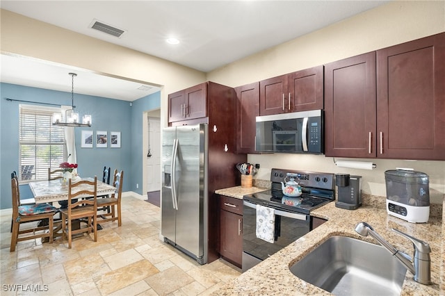 4551 Fort Center Ave, Fort Denaud, FL 33935 - kitchen with a sink, hanging light fixtures, appliances with stainless steel finishes, light stone countertops, and visible vents