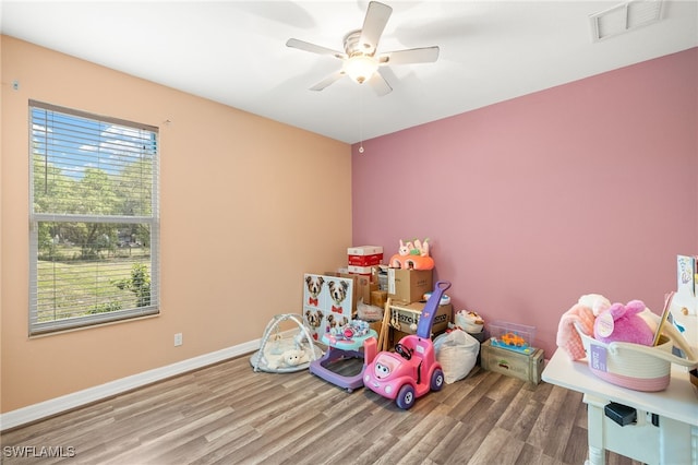 4551 Fort Center Ave, Fort Denaud, FL 33935 - playroom with wood finished floors, visible vents, a ceiling fan, and baseboards