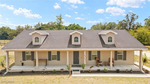 4551 Fort Center Ave, Fort Denaud, FL 33935 - farmhouse inspired home with stucco siding, roof with shingles, a porch, and a front yard