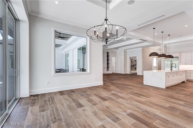 unfurnished dining area with light wood finished floors, an inviting chandelier, and recessed lighting