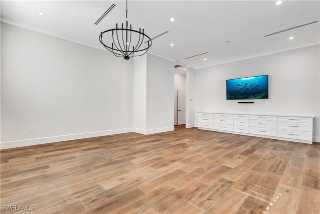 unfurnished living room featuring light wood finished floors, baseboards, a notable chandelier, and crown molding