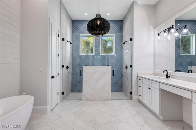 bathroom featuring recessed lighting, a shower stall, vanity, baseboards, and a soaking tub