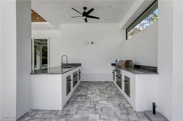 view of patio / terrace featuring grilling area, a sink, area for grilling, and ceiling fan