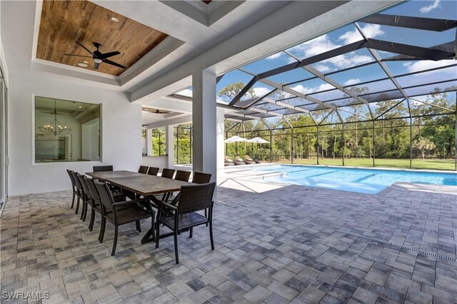 pool featuring ceiling fan, outdoor dining area, glass enclosure, and a patio