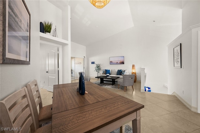 dining room featuring high vaulted ceiling and light tile patterned floors