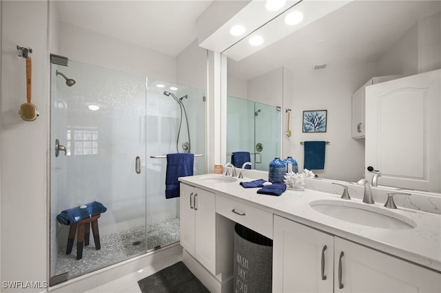 full bathroom featuring visible vents, a sink, double vanity, and a stall shower