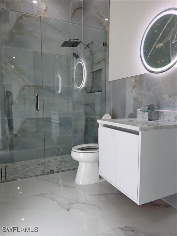 528 Aspen Ave S, Lehigh Acres, FL 33974 - full bath with tile walls, vanity, a stall shower, toilet, and marble tiled flooring