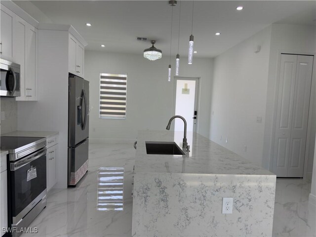 528 Aspen Ave S, Lehigh Acres, FL 33974 - kitchen featuring stainless steel appliances, a sink, light marble finish flooring, recessed lighting, and white cabinets