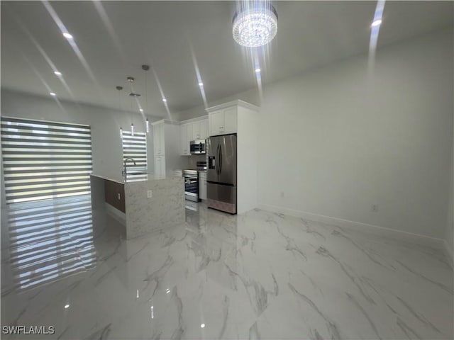 528 Aspen Ave S, Lehigh Acres, FL 33974 - unfurnished living room with baseboards, a sink, light marble finish flooring, and a chandelier