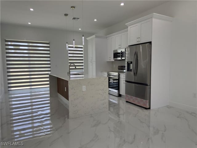528 Aspen Ave S, Lehigh Acres, FL 33974 - kitchen with stainless steel appliances, a sink, recessed lighting, white cabinets, and pendant lighting