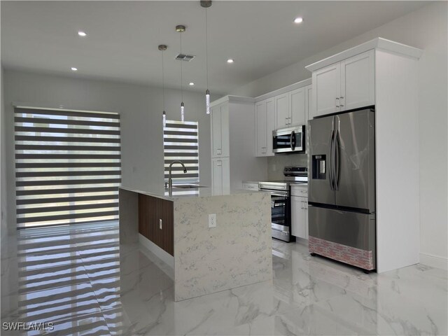 528 Aspen Ave S, Lehigh Acres, FL 33974 - kitchen with appliances with stainless steel finishes, a sink, recessed lighting, white cabinets, and pendant lighting