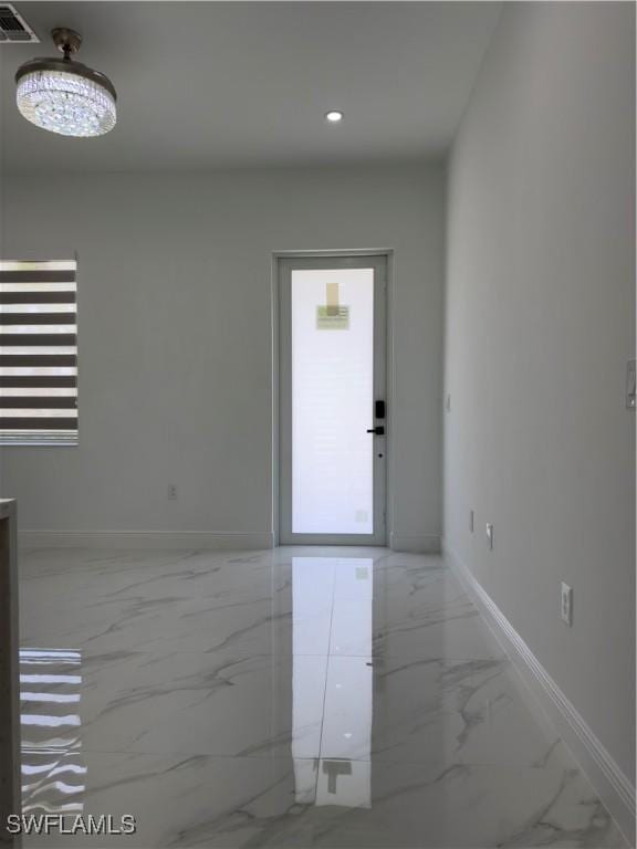 528 Aspen Ave S, Lehigh Acres, FL 33974 - empty room with marble finish floors, baseboards, and recessed lighting