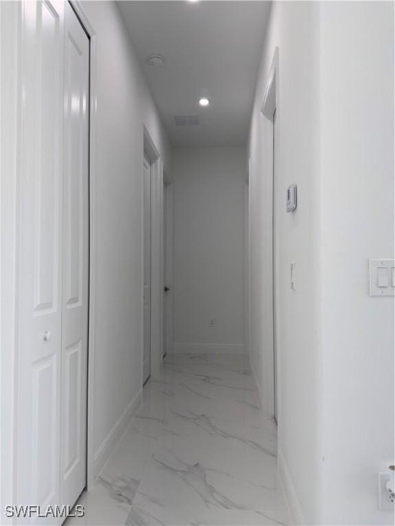 528 Aspen Ave S, Lehigh Acres, FL 33974 - corridor with baseboards, light marble finish floors, and recessed lighting