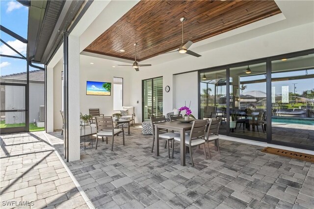 2008 SW 44th Ter, Cape Coral, FL 33914 - view of patio with outdoor dining area, a ceiling fan, glass enclosure, and an outdoor pool