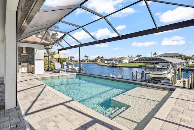 2008 SW 44th Ter, Cape Coral, FL 33914 - swimming pool with boat lift, a dock, a patio area, a water view, and exterior kitchen