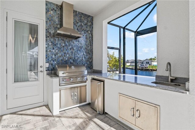 2008 SW 44th Ter, Cape Coral, FL 33914 - kitchen with wall chimney range hood, a sink, fridge, backsplash, and a water view
