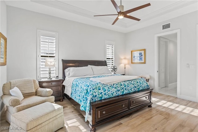 2008 SW 44th Ter, Cape Coral, FL 33914 - bedroom with light wood-type flooring, a tray ceiling, baseboards, and a ceiling fan