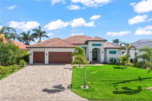 2008 SW 44th Ter, Cape Coral, FL 33914 - mediterranean / spanish home featuring a garage, a front yard, decorative driveway, stucco siding, and a tiled roof
