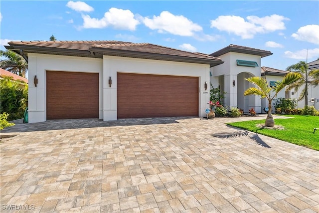 2008 SW 44th Ter, Cape Coral, FL 33914 - view of front facade with an attached garage, a tile roof, decorative driveway, and stucco siding