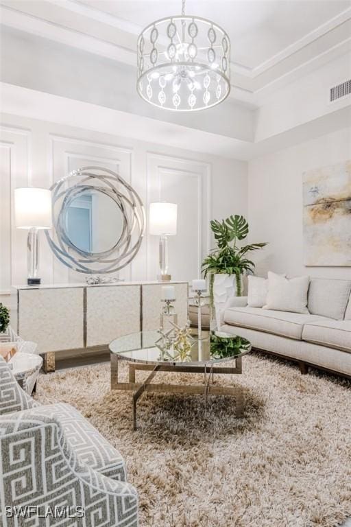 living area featuring visible vents and crown molding
