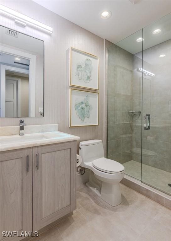 full bath featuring a shower stall, vanity, tile patterned floors, toilet, and visible vents