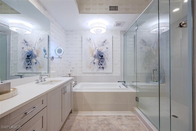 bathroom featuring a garden tub, a shower stall, visible vents, and vanity