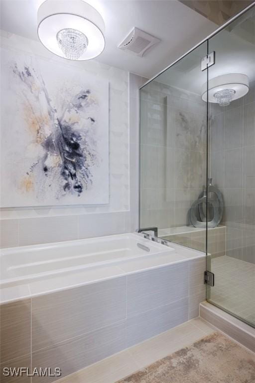 bathroom with visible vents, a shower stall, a garden tub, and tile patterned flooring