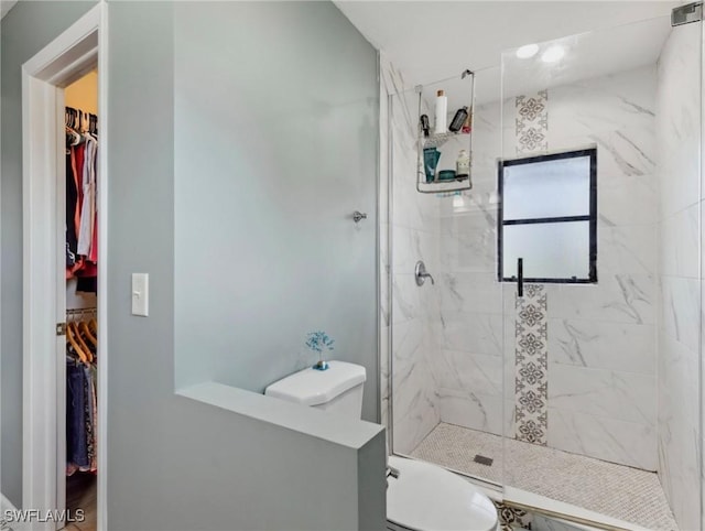 6030 Birnam Wood Ln, Fort Myers, FL 33908 - bathroom featuring a shower stall, a walk in closet, and toilet