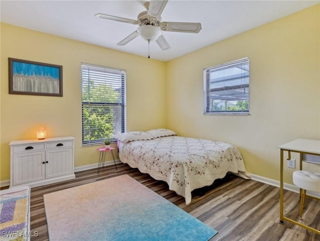6030 Birnam Wood Ln, Fort Myers, FL 33908 - bedroom with wood finished floors, baseboards, and multiple windows