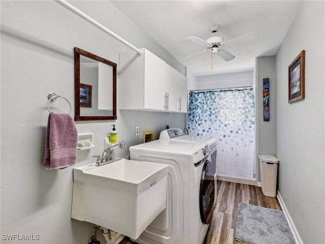 6030 Birnam Wood Ln, Fort Myers, FL 33908 - laundry room with wood finished floors, a ceiling fan, a sink, washing machine and dryer, and cabinet space