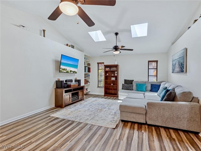 6030 Birnam Wood Ln, Fort Myers, FL 33908 - living area with lofted ceiling with skylight, wood finished floors, baseboards, and ceiling fan