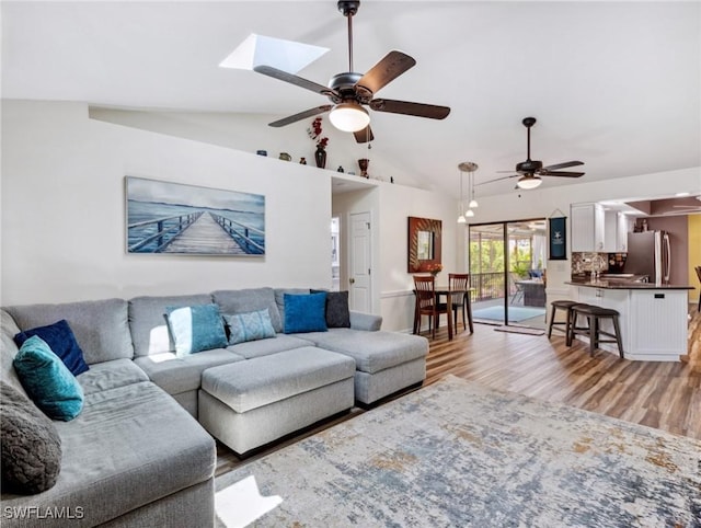 6030 Birnam Wood Ln, Fort Myers, FL 33908 - living room with a skylight, a ceiling fan, high vaulted ceiling, and light wood-style floors