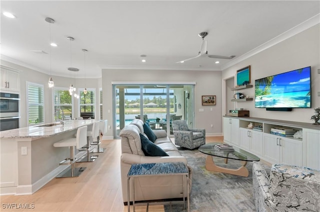16733 Gilroy St, Bonita Springs, FL 34135 - living room with crown molding, light wood finished floors, plenty of natural light, recessed lighting, and baseboards