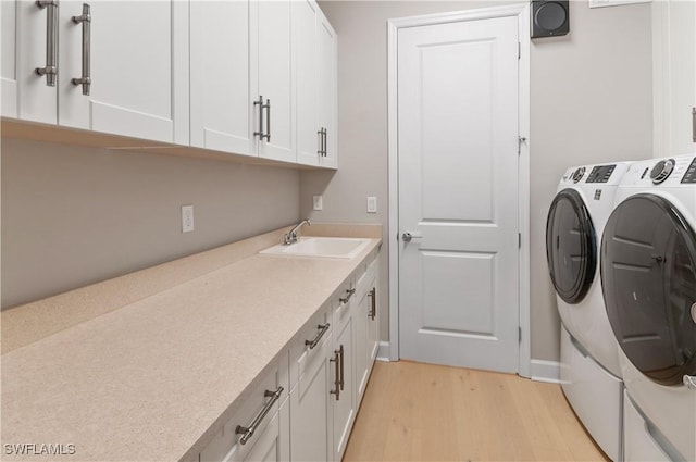 16733 Gilroy St, Bonita Springs, FL 34135 - laundry room featuring washer and clothes dryer, light wood finished floors, cabinet space, and baseboards